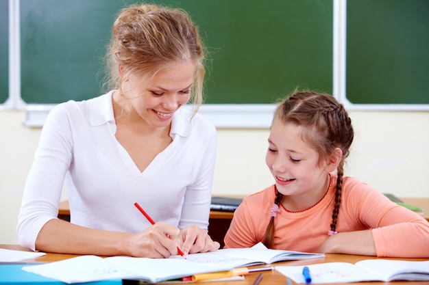 Teacher and student working in class