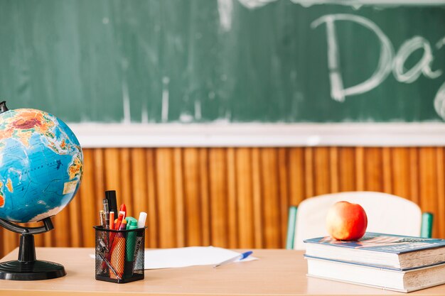 Teacher table with writing supplies