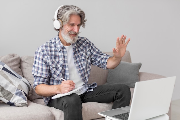 Teacher waving at laptop