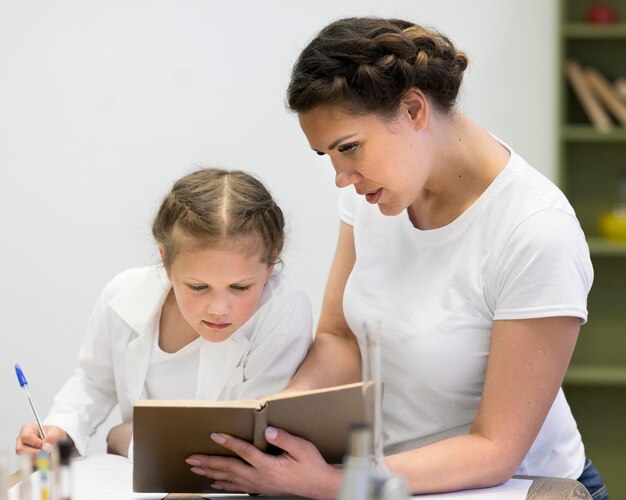 Teacher with girl at class