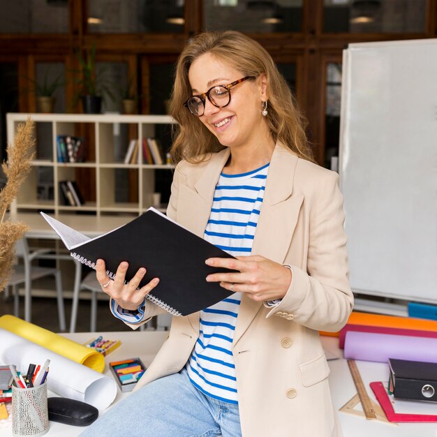 Teacher with notebook reading