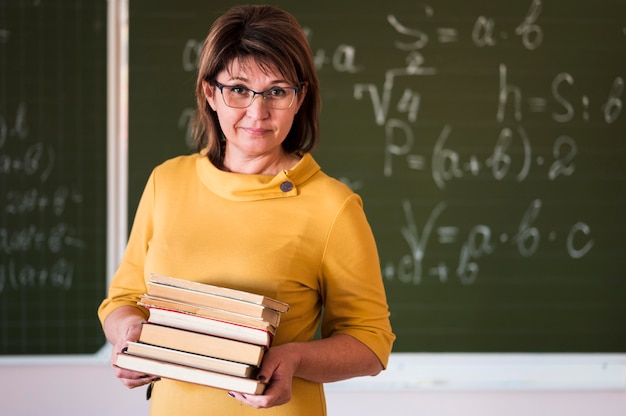 Teacher with stack of books