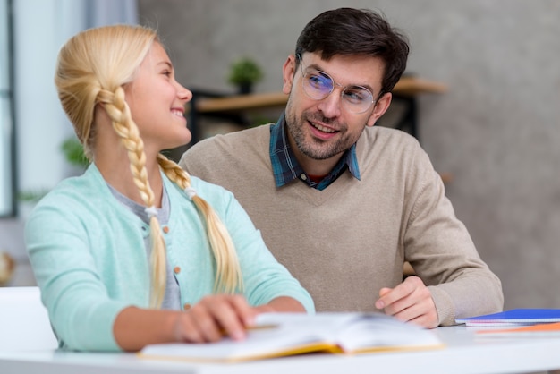 Teacher and young student being content