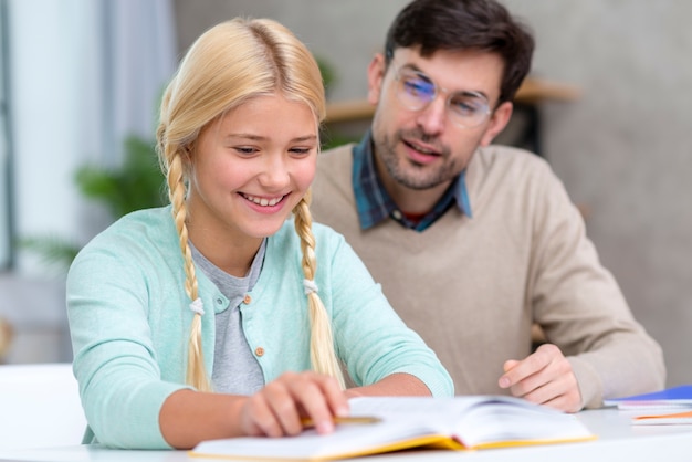 Free photo teacher and young student being happy