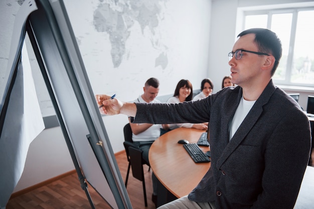 Teaching process. Group of people at business conference in modern classroom at daytime