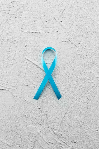 Free photo teal ribbon on plaster background