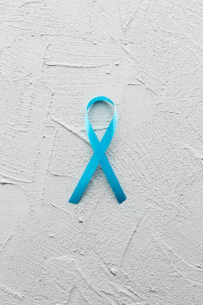 Teal ribbon on plaster background