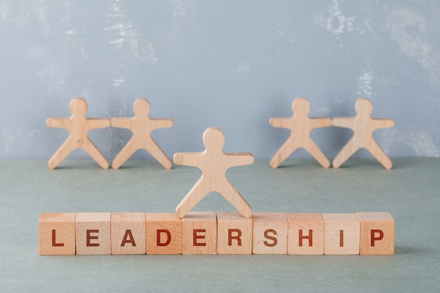 Team building and business concept with wooden blocks with words on it, wooden human figures side view.