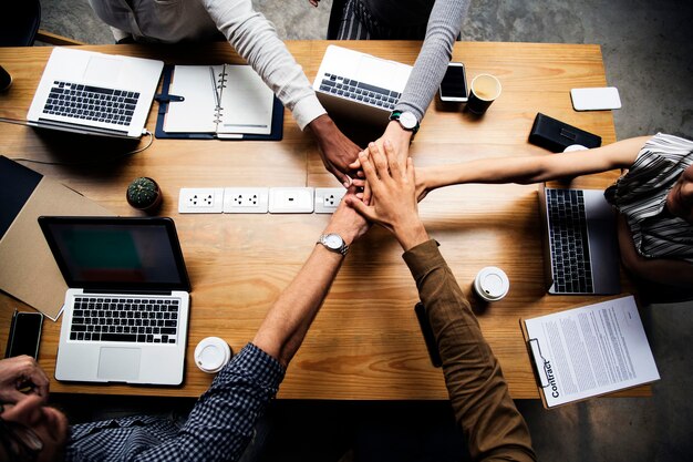 team of business people stacking hands