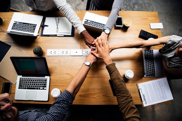 Team of business people stacking hands