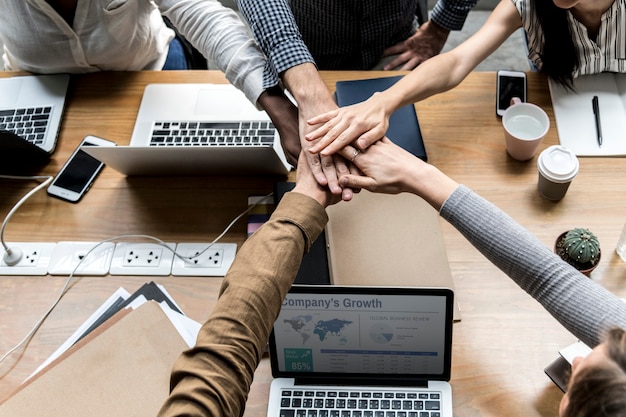 team of business people stacking hands