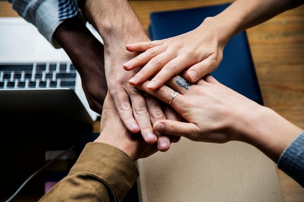 Team of business people stacking hands