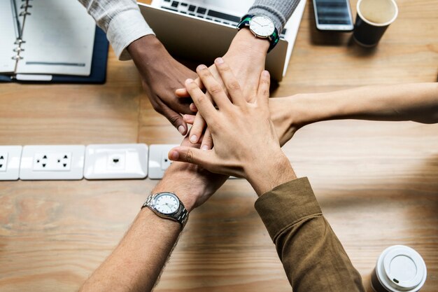 Team of business people stacking hands