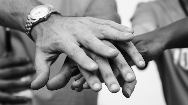 Team of business people stacking hands