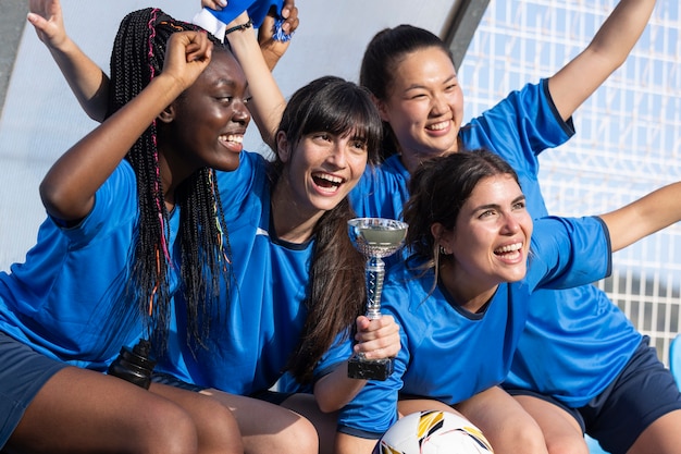 Free photo team celebrating the win of silver cup