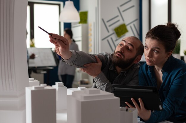 Team of construction architects work on tablet at office