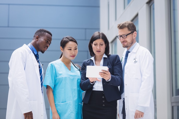 Team of doctors looking at digital tablet