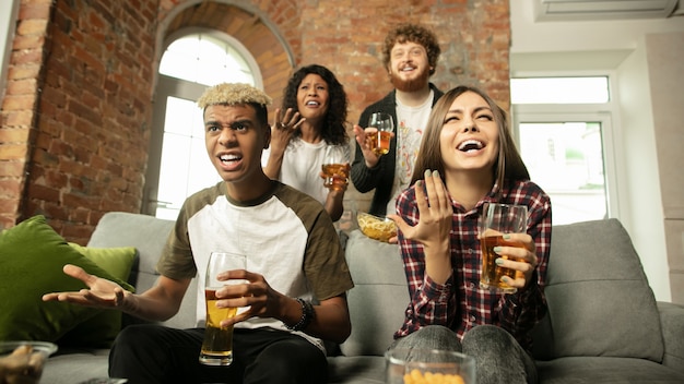 Team. excited people watching sport match, championship at home. multiethnic group of friend, fans cheering for favourite sport team