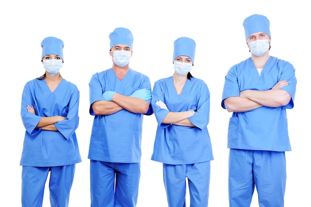 Free photo team of four surgeons in blue uniform standing together