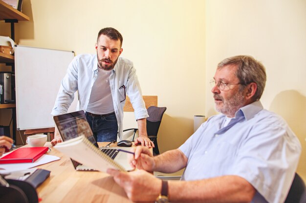 Team job. Photo young businessmans working with new project in office