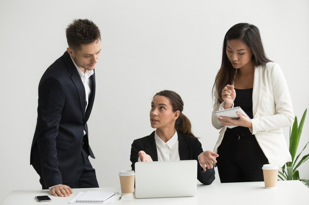 Team leader training colleagues in office