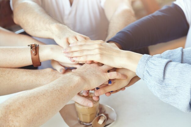 Team of young colleagues having meeting at cafe