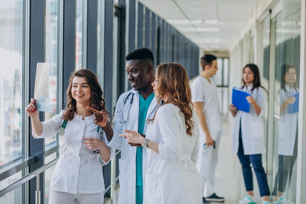 team of young specialist doctors standing in the corridor of the hospital