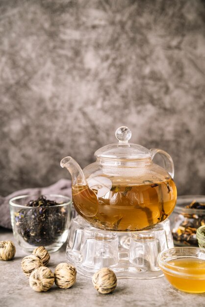 Teapot filled and walnuts on marble background