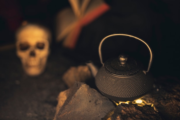 Teapot high view with blurred skull in background