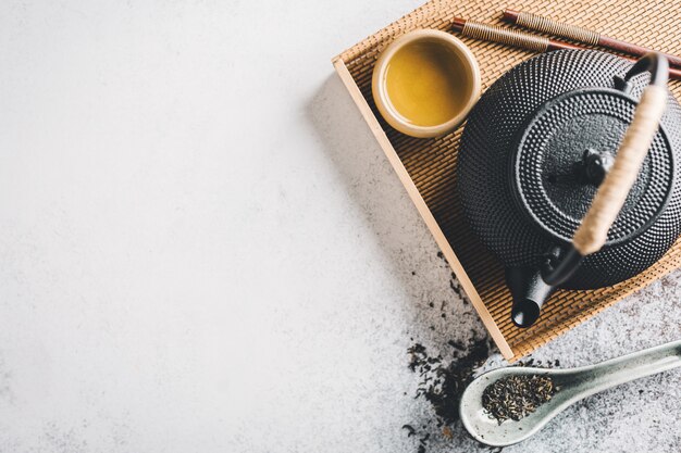 Teapot with tea on bright 