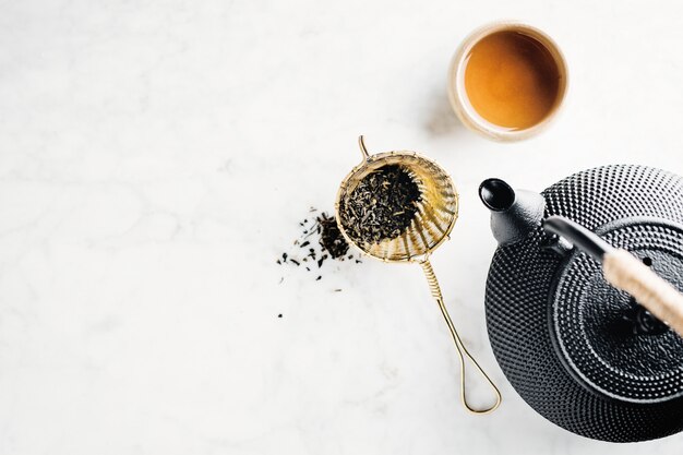 Teapot with tea on bright 