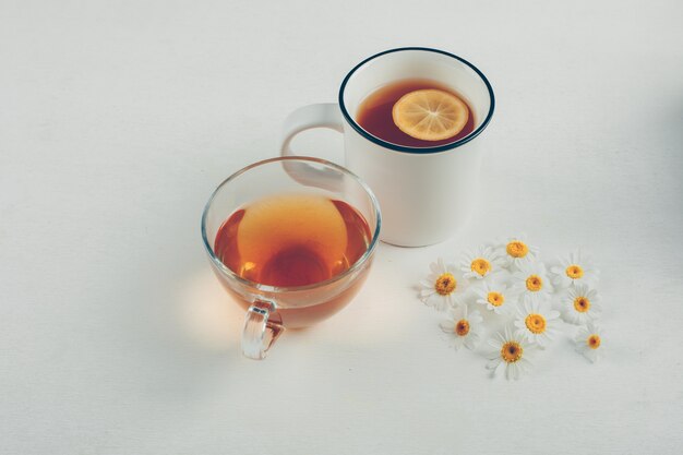 Teas and flowers in a cups. high angle view.