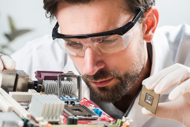 Free photo technician checking microchip slot in computer motherboard