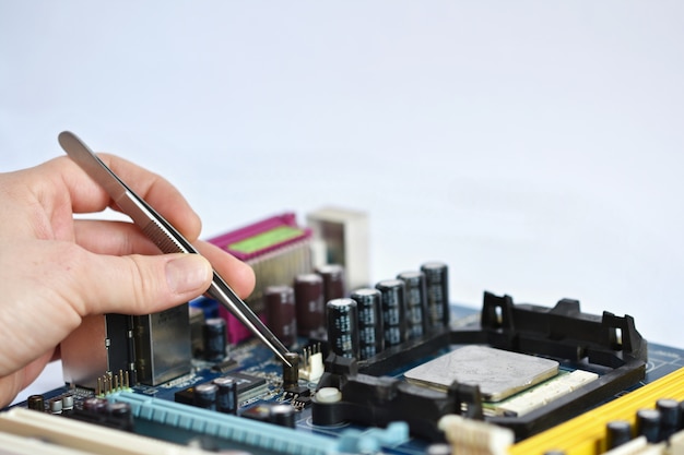 Technician placing a chip with pliers