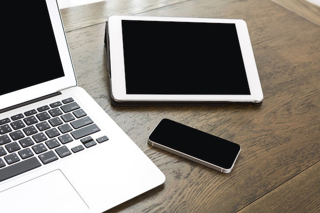 Technological devices on wooden table