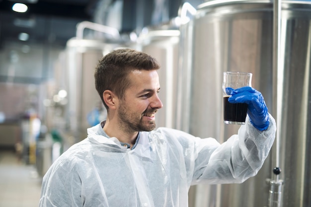 Free photo technologist checking product quality in beverage alcohol production plant