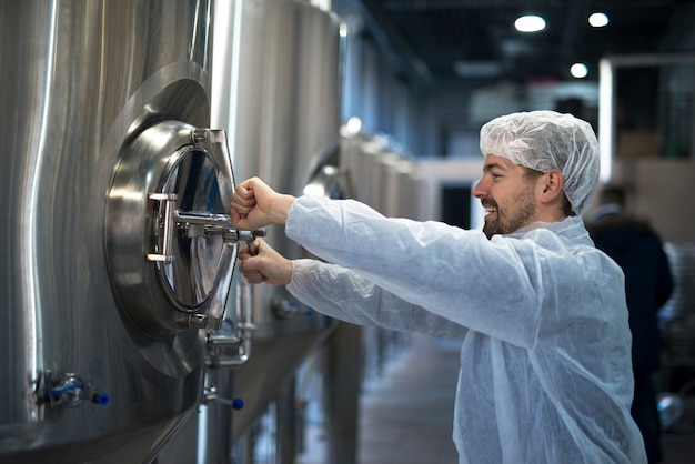 Technologist working in food processing factory checking quality and production