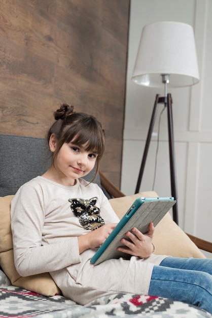 Free photo technology concept with girl on couch