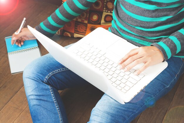 Technology, shopping, banking, home and lifestyle concept - close up of female with laptop computer at home