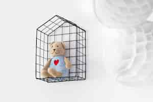 Free photo teddy bear in a cage