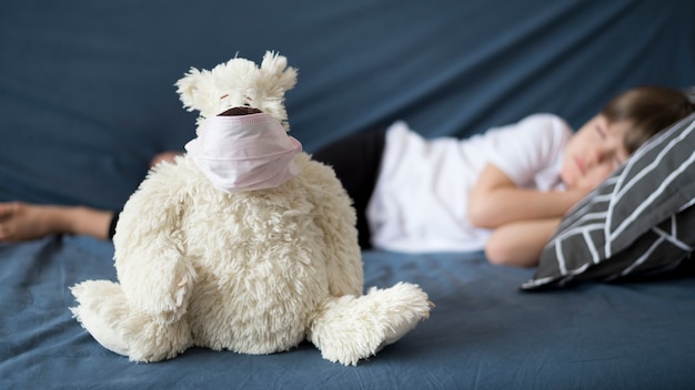 Free photo teddy bear with surgeon mask