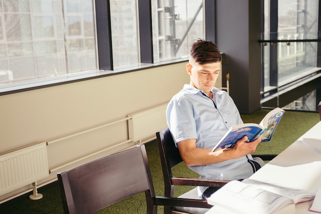 Teen boy reading book