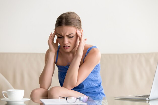 Teen girl having panic attack, feeling dizzy headache, massaging