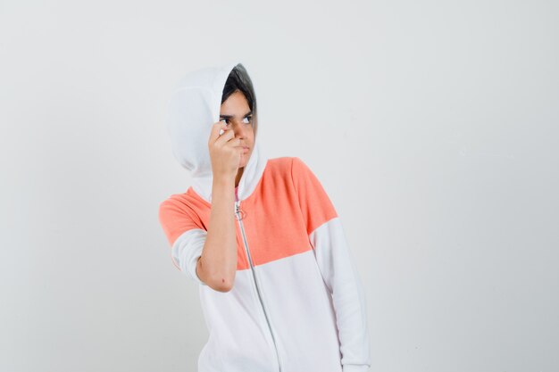 Teen girl hiding from someone in white jacket