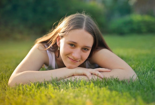 teen girl lying on a grass in a park
