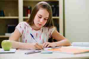 Free photo teen girl sitting and writing