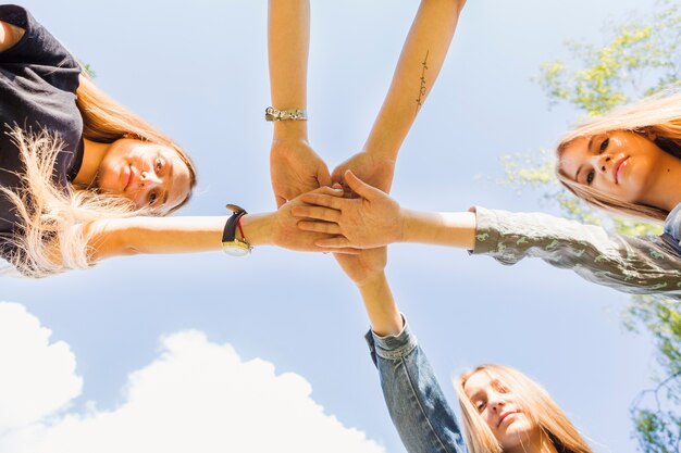 Teen girls holding hands together