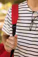 Free photo teen student with glasses carrying backpack