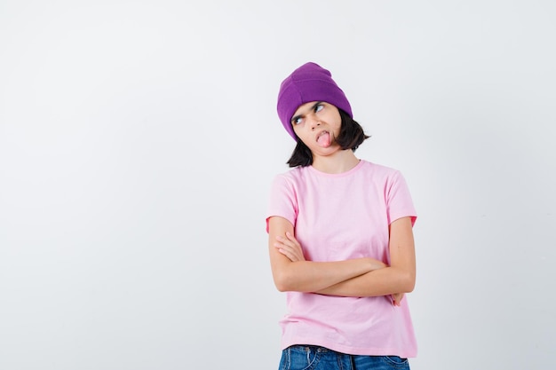 Teen woman in checkered shirt and beanie gesticulating isolated