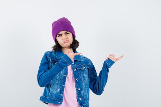 Teen woman in checkered shirt and beanie gesticulating isolated